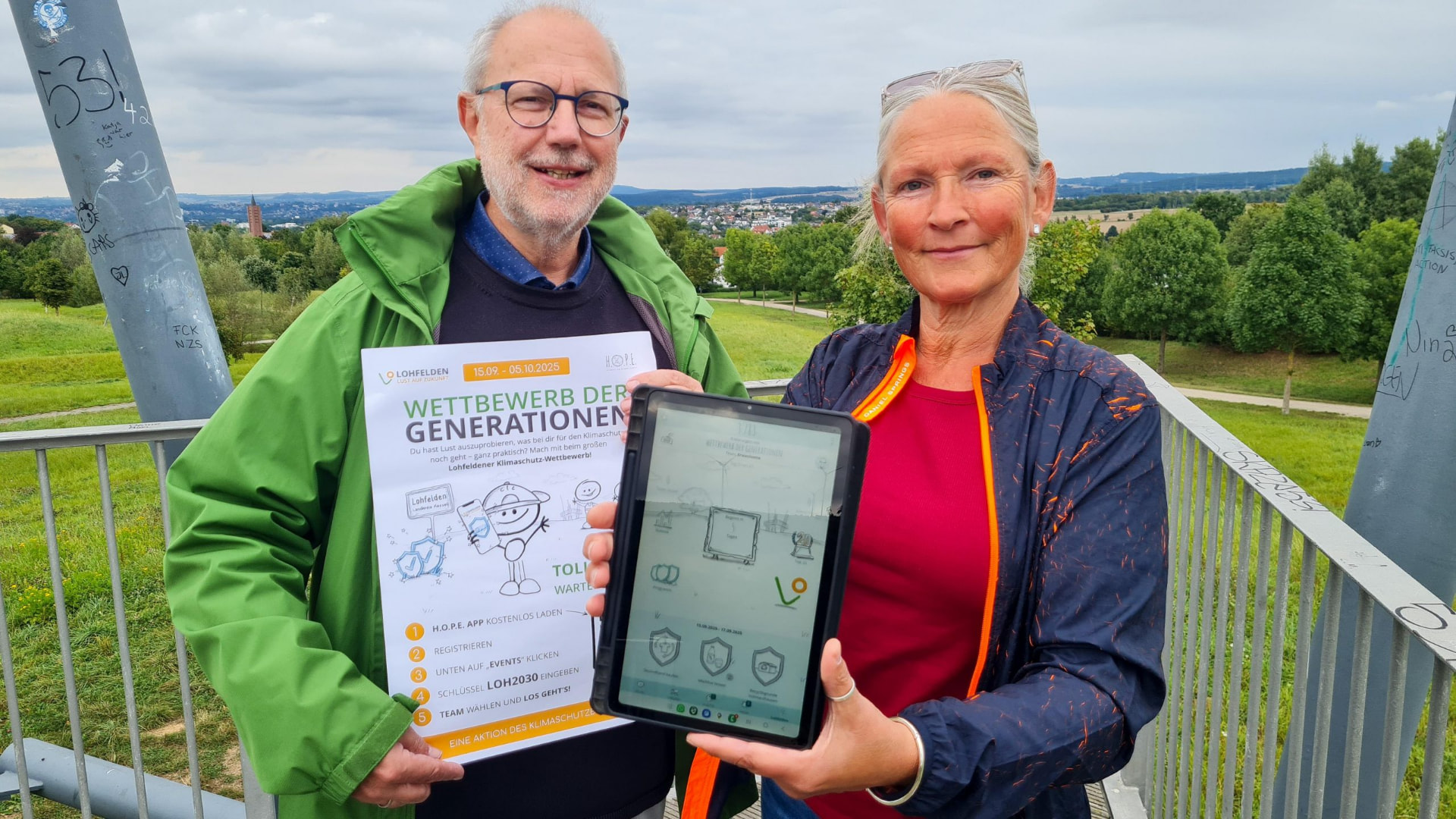 Zwei Personen präsentieren den Lohfeldener Klima-Wettbewerb der Generationen mit der H.O.P.E. App